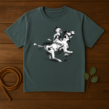 Load image into Gallery viewer, Green t-shirt with a graphic of a person riding a horse on a wooden surface.