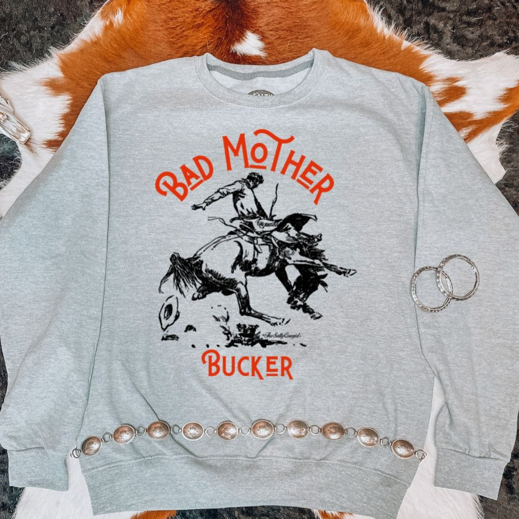 Flat lay of Bad Mother Bucker sweatshirt. Laying on a cowhide rug
