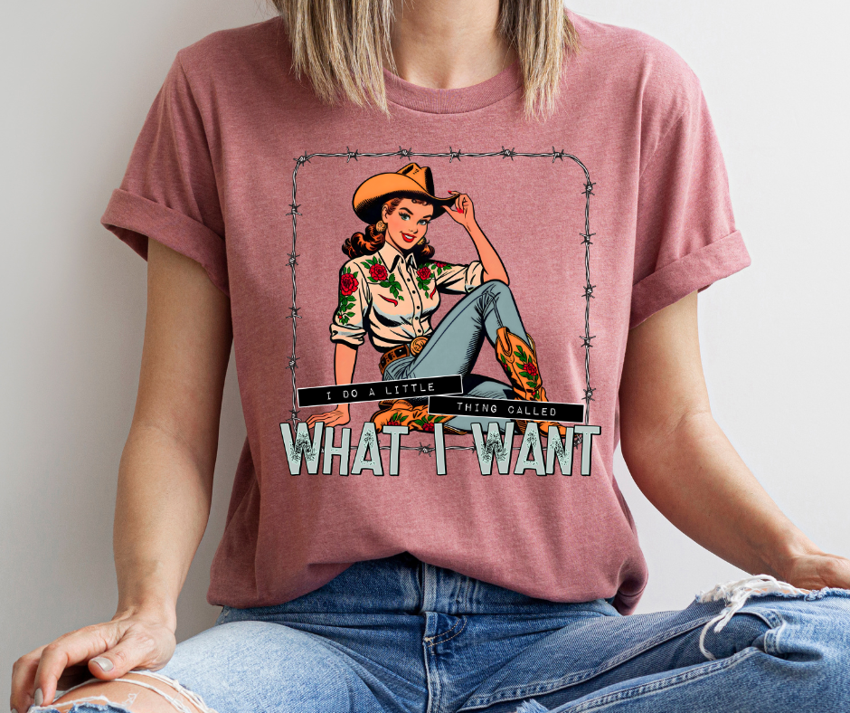 Person wearing a pink t-shirt with a graphic design and text.