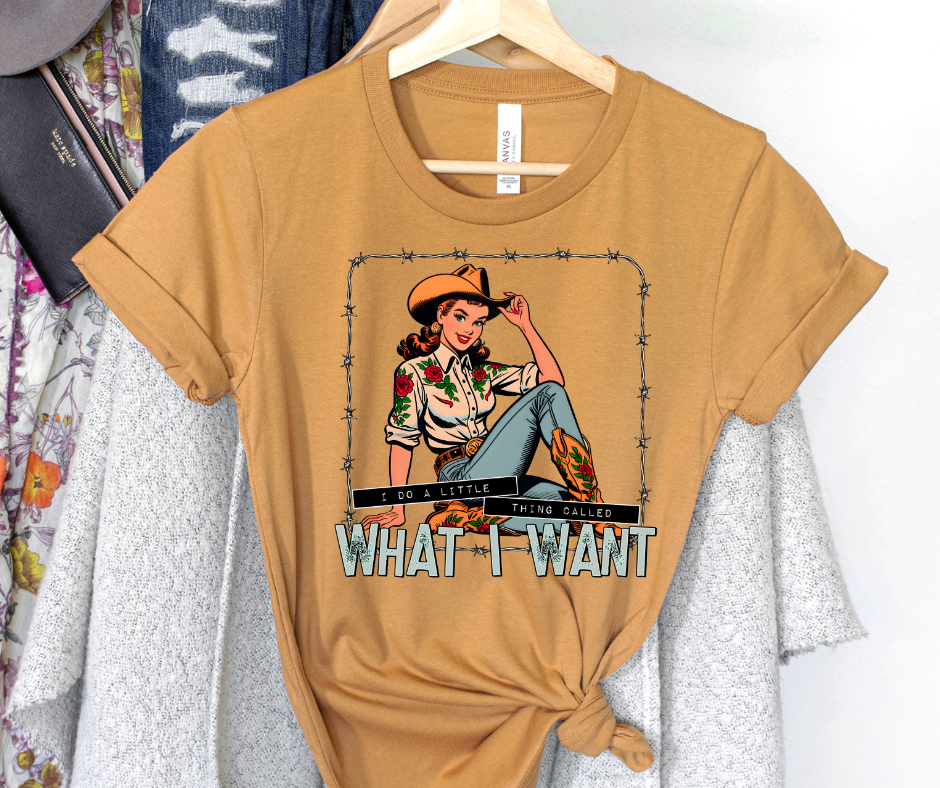 Brown t-shirt with graphic design and text on a hanger against a white background