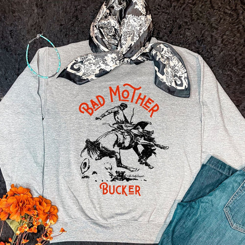 Grey Bad Mother Bucker sweatshirt with a black and white wild rag and pair of jeans. 